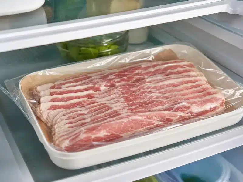 Raw bacon sealed on a refrigerator shelf - bacon | EpicureDelight
