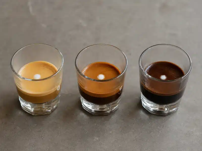 Pale balanced and dark espresso shots with small foam marks