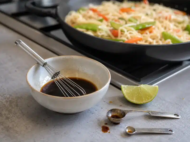 Soy sauce and lime mixture beside cooked noodles - fish sauce substitute | EpicureDelight